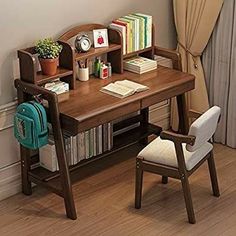 a wooden desk with a chair next to it and books on the shelf in front