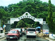 cars driving under a sign that reads paguapuu