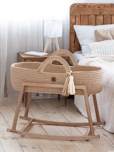 a wicker baby's cradle in front of a bed