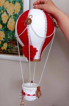 a red and white hot air balloon is being held