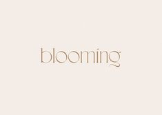 the word blooming written in gold on a white background