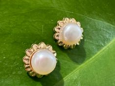 Vintage 14k Solid Gold and Genuine Pearl Flower Post Earrings Description: These Vintage 14k Solid Gold and Genuine Pearl Flower Post Earrings feature a classic design with natural white pearls set in elegant 14k solid gold. The earrings weigh 1.23g, with each earring measuring 9.8mm in diameter and a pearl diameter of 6.4mm. The floral design adds a timeless charm, perfect for any occasion. Personalize it! Wear it alone for a bold, classic, minimalistic vibe or layer and stack with dainty to st Classic Yellow Gold Flower Earrings For Formal Occasions, Elegant Round Flower Earrings Hallmarked, 14k Gold Round Flower Earrings For Formal Events, Elegant Yellow Gold Flower-shaped Pearl Earrings, Classic Round Flower Earrings For Formal Occasions, Elegant Yellow Gold Flower Pearl Earrings, Classic 14k Gold Flower Earrings For Anniversary, Classic Flower-shaped Pearl Earrings For Formal Occasions, Formal Yellow Gold Flower Pearl Earrings