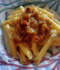 pasta with meat and sauce on a colorful floral pattern plate, ready to be eaten