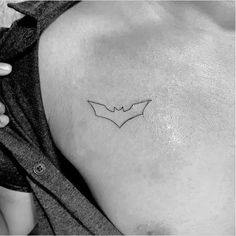 a small bat tattoo on the chest