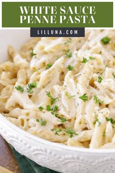 white sauce penne pasta in a bowl with parsley on top and text overlay