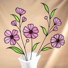 a white vase filled with pink flowers on top of a table