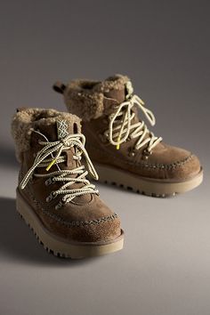 Rooted in UGG® heritage, this boot showcases iconic features like the curly sheepskin collar, UGGplush lining, and smooth suede upper. Round laces and Heritage Twin Seam details give this booth depth, while the lug sole provides traction for those first-snowfall walks. | Classic Alpine Lace-Up Boots by UGG in Brown, Women's, Size: 6, Polyester/Leather/Wool at Anthropologie Womens Snow Boots Outfit, Cute Boots For Winter, Winter Boots 2024, Women’s Winter Boots, Women’s Boots, Winter Boots Aesthetic, Fuzzy Winter Boots, Snow Boots Outfit, Cute Snow Boots