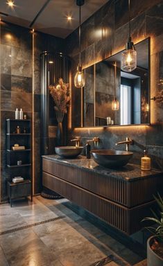 a large bathroom with two sinks and lights on the wall, along with a walk in shower