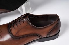 Modernist's choice dress shoes, made from cow leather and lined with pigskin, offering a sleek and stylish option. Fitted Leather Oxfords For Business Casual, Spring Leather Fitted Oxfords, Fitted Leather Oxfords With Pointed Toe, Luxury Business Dress Shoes For Spring, Luxury Dress Shoes For Business In Spring, Elegant Leather Oxfords For Spring, Spring Leather Oxfords In Elegant Style, Fitted Leather Shoes With Brogue Detailing For Office, Brown Leather Shoes For Semi-formal Spring Events