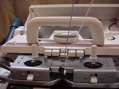 an old sewing machine sitting on top of a table