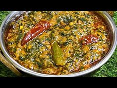 a metal pan filled with food on top of green grass