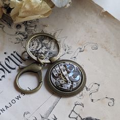 Looking for a one-of-a-kind anniversary gift for your husband? Look no further than this stunning steampunk-inspired old watch movement keychain. With its rich Bronze colour and impressive craftsmanship, this keychain is a true statement piece. A perfect blend of tradition and innovation, it will remind him of timeless love every time he reaches for his keys. Made with authentic Swiss watch movement in a bronze tone pendant. Good size clasp in matching, bronze colour; pendant with watch measures 30 mm / 1 1/4inch This fabulous bronze keychain will arrive packed in a lovely organza bag, just ready for gift giving ------ For more of my handmade jewellery, just click on the links below - Shop Home https://www.etsy.com/uk/shop/KfiatekGiftedHands - Keychains - http://etsy.me/2fUOHtx Please add Wedding Anniversary Gift For Husband, Bronze Anniversary Gifts, Bronze Anniversary, Bronze Wedding, Old Watch, Bronze Colour, Fountain Pens Calligraphy, Custom Cufflinks, Anniversary Gift For Husband