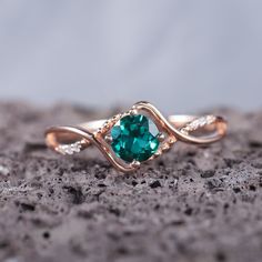 a close up of a ring with a green stone