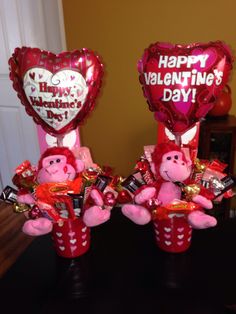 two valentine's day decorations with pink teddy bears and heart balloons