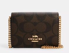 New with Tags a COACH authentic Mini Wallet on a Chain in Signature Canvas and Leather in Gold/Brown Black in Manufacturer wrapping! Sorry, at this time, we are not part of the Global Shipping Program and cannot ship international or to anyone who uses a third-party shipping company as a United States address. Features on Mini wallet from Manufacturer! Measures approximately 4"L x 3"W x 1"D and style number is 6650.  GOLD-PLATED HARDWARE! Signature coated canvas and smooth leather with two credi Coach Wallet On Chain With Details, Coach Gold Wallet On Chain With Chain Strap, Gold Rectangular Coach Wallet On Chain, Coach Wallet On Chain, Coach Mini Wallet, Harry Potter 9, Universal Studios Florida, Coach Wallet, Signature Canvas