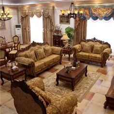 a living room with couches, chairs and tables in the middle of the room