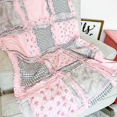 a pink and gray quilt on a chair