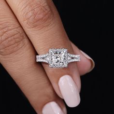 a woman's hand with a diamond ring on top of her finger and an engagement band