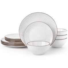 white and gold dinnerware set on a white background