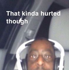 a man wearing headphones sitting in the back seat of a car