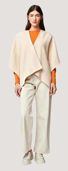 The Athena Jacket from SOIA & KYO is a classic shawl-style jacket perfect for light wear. The Athena Jacket drapes over the shoulders and features wide sleeves, a functional front pocket for all of your essentials, and a stylish, over-the-knee, asymmetrical hemline to add a striking fashionista element to this timeless must-have. Beige Shawl Collar Outerwear For Spring, Beige Long Sleeve Cape For Work, Long Sleeve Beige Cape For Work, Spring Outerwear For Layering With Shawl Collar, Chic Shawl Outerwear For Spring, Chic Spring Outerwear Shawl, Spring Shawl Collar Outerwear For Layering, Spring Layering Cape Outerwear, Elegant Spring Shawl Outerwear