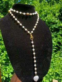 This chain is 30 inches long with a 7 inch drop from the top of the hand centerpiece. This necklace does not have a clasp and probably won't wrap around, I just had to do that to make it fit on my stand!  This piece is made of genuine Australian pink opal, rose quartz, and peach moonstone 💖 Adjustable Long Drop Necklace With Chain, Adjustable Long Chain Drop Necklace, Pearl Lariat Necklace With Chain, Bohemian Lariat Necklace With Pearl Chain, White Lariat Chain Jewelry, White Lariat Necklace With Beaded Chain, White Beaded Chain Lariat Necklace, Adjustable Lariat Long Necklace With Chain, Adjustable White Lariat Chain Necklace