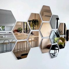 a bunch of hexagonal mirrors hanging on the wall in front of a kitchen