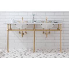 two white sinks sitting next to each other on top of a tiled floor in a bathroom