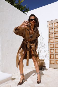 Length from shoulder to hem of size S: 128cm. Brown trench coat. Model is a standard S and is wearing size S. Lined. Gentle cold machine wash, do not tumble dry, warm iron. True to size. Button closure. Waist-ties. Twin inseam hip pockets. PU. Feel That Chill Then, it's time to bring the fire with this faux leather coat. This has an elegant double button detail with a structured fit, making it the perfect coat for any look. Style yours with heels and sunnies. Oversized Beige Raincoat For Fall, Trendy Brown Summer Outerwear, Chic Long Sleeve Raincoat For Fall, Oversized Long Raincoat For Fall, Brown Long Outerwear For Spring, Belted Long Raincoat For Fall, Long Brown Outerwear For Spring, Long Brown Spring Outerwear, Belted Long Sleeve Raincoat For Fall