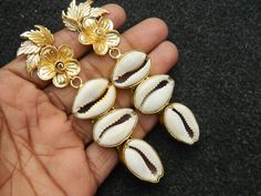 This listing is for 1 pair of Cowrie Shell Earring Cowrie Brass earring Gold plated Cowrie Shell earring Bridesmaid charm earring Unique Fashion jewelry Bohemian. Size: 81 mm long. Made with Love♥ Best for gift . Light Weight comfortable to wear Many thanks for you visit my store ♥ if you have any question please contact us. For wholesale Price Please Convo me. You can order different items as many you like . Metal Drop Earrings For Beach, Bohemian Gold Flower Earrings For Beach, Beach Drop Earrings In Metal, Beach Metal Drop Earrings, Gold Cowrie Shell Earrings As Gift, Gold Shell-shaped Earrings For Wedding, Shell-shaped Metal Earrings For Gift, Dangle Cowrie Shell Earrings For Beach, Gold Shell-shaped Earrings For Party