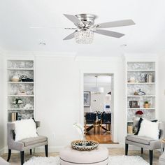 a living room filled with furniture and a ceiling fan