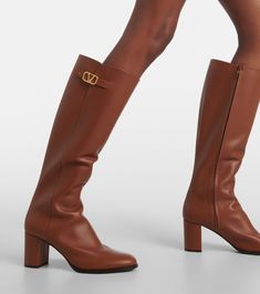 Vlogo Signature leather knee-high boots in brown - Valentino Garavani | Mytheresa Designer Knee-high Boots With Leather Lining, Luxury Knee-high Boots With Leather Lining, Luxury Brown Knee-high Boots For Business, Brown Knee-high Formal Boots, Classic Cognac Calf Leather Heeled Boots, Designer Leather Knee-high Boots, Luxury Brown Knee-high Heeled Boots, Formal Brown Knee-high Boots With Leather Sole, Formal Brown Knee-high Boots With Reinforced Heel