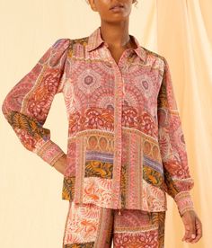 DESCRIPTION Infuse your wardrobe with the vibrant allure of the Julia Shirt in Riviera by Kachel. This elegant shirt is adorned with a mesmerising patchwork of intricate patterns in warm, earthy tones, evoking a sense of bohemian charm. The button-front design, coupled with a classic collared neckline, provides a timeless look, while the long puffed sleeves add a touch of vintage-inspired flair. Crafted from 100% viscose habutai, this shirt is lightweight and drapes beautifully, ensuring comfort Multicolor Long Sleeve Silk Shirt, Long Sleeve Multicolor Silk Shirt, Long Sleeve Silk Blouse With Vibrant Print, Multicolor Print Long Sleeve Silk Blouse, Multicolor Print Silk Long Sleeve Blouse, Silk Long Sleeve Multicolor Print Blouse, Silk Long Sleeve Blouse In Multicolor Print, Multicolor Print Long Sleeve Silk Top, Silk Tops With Vibrant Print And Long Sleeves