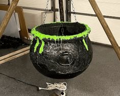 a large black pot with green paint on it