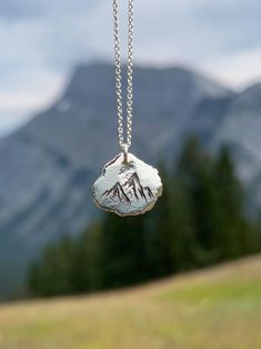 Remember your personalized journey through loss or challenging circumstances with a solid silver nugget engraved with a beautiful nature symbol. Hold your loss and link to nature close to your heart. Chose the symbol that resonates with you the most: -Daisy -Dandelion poof -Dragonfly -Footprints -Forget-me-not  -Mushroom -Mountains -Trees -Sand Dollars *1-2 Letters or Numbers able to be engraved on the back.  Each of these pendants is 100% unique. Made from high quality recycled silver, they are Nature-inspired Stamped Jewelry For Everyday, Antique Silver Stamped Jewelry For Gift, Everyday Silver Nature-inspired Jewelry, Nature-inspired Stamped Sterling Silver Jewelry, Nature-inspired Sterling Silver Etched Jewelry, Nature-inspired Etched Sterling Silver Jewelry, Symbolic Hand Stamped Sterling Silver Jewelry, Nature-inspired Silver Hand Stamped Jewelry, Nature-inspired Etched Jewelry Gift