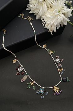 This necklace is a dainty, delightful piece. With a collection of quirky little unit, embellished with colorful stones and pearls, this necklace is perfect piece for the lovers of eccentric designs. Closure - Lobster Style Tip - Meet the perfect amalgam of poetic romance and the surrealism of fairy tales. Reminding us of clear starlit skies, magic and all the poems about love and passion, these designs are perfect for someone who wishes to add poetic details to their selections which are also re White Gemstone Necklace For Party, White Gemstone Party Necklace, White Jeweled Kundan Necklace Gift, Unique Multicolor Jeweled Necklaces, White Gemstone Temple Jewelry Necklace, White Temple Jewelry Necklace With Gemstone, White Jeweled Necklaces For Festivals, White Jeweled Necklace For Festivals, Festival White Gemstone Necklace