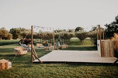 an outdoor stage set up with hay bales and string lights