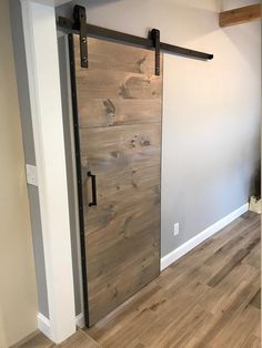 an empty room with a sliding door and hard wood flooring on the side wall