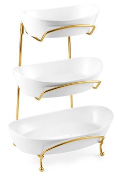 three tiered trays with gold handles and white dishes on each side, one holding two