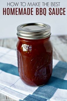 a jar filled with homemade bbq sauce on top of a checkered table cloth