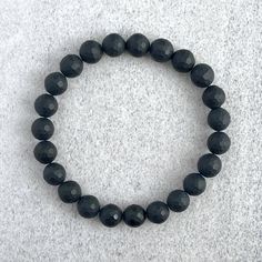 ~ 6mm or 8mm Faceted Matte Onyx beads ~ Stretchy cord; simply slide bracelet on and off wrist ~ Comes packaged in a re-usable micro fibre pouch To ensure the perfect fit, please use the bracelet sizing instructions found in the photo gallery. Adjustable Black Bracelets For Everyday, Casual Black Stretch Bracelet For Everyday, Adjustable Stretch Bracelet With Faceted Beads For Everyday, Adjustable Minimalist Wristband With Round Beads, Minimalist Adjustable Wristband With Round Beads, Minimalist Black Wristband With Round Beads, Hypoallergenic Black Round Bracelets, Adjustable Onyx Stretch Bracelet With Round Beads, Stretch Bracelet With 8mm Beads