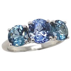 three stone ring in white gold with blue topazte and tanzante accents