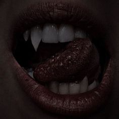 a woman's mouth with white teeth and dark lipstick