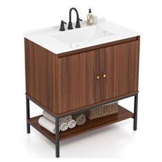 a bathroom vanity with a sink and towel rack on the bottom, next to towels