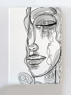 a black and white drawing of a woman's face on a piece of paper