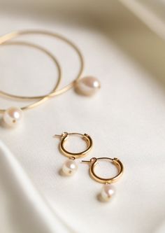 An everyday classic. Polished pearl hoops to give you a classic modern look. • Available in 14k gold filled • Available in 15mm or 18mm hoops • Made in United States Classic 14k Gold Filled Hoop Earrings For Everyday Luxury, Classic Everyday Pearl Drop Jewelry, Classic Round Pearl Earrings For Everyday, Timeless Everyday Pearl Earrings, 14k Yellow Gold Filled Round Pearl Earrings, Everyday Pearl Charm Huggie Jewelry, Everyday Huggie Jewelry With Pearl Charm, Elegant Everyday Pearl Huggie Earrings, Minimalist 14k Gold Filled Huggie Earrings With Pearl Charm