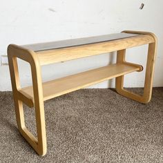 a wooden bench sitting on top of a carpeted floor