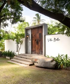 the entrance to villa bleu is surrounded by greenery and stone steps that lead up to the front door