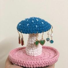 a small crocheted mushroom with earrings on it