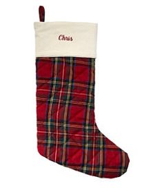 a red plaid christmas stocking with the name christ on it and a white background